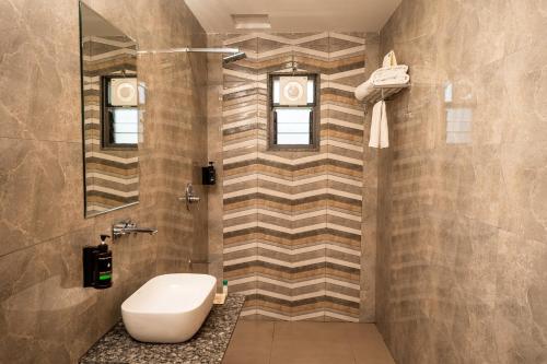 a bathroom with a sink and a toilet in it at Daksh The Grand Goverdhan in Dwarka