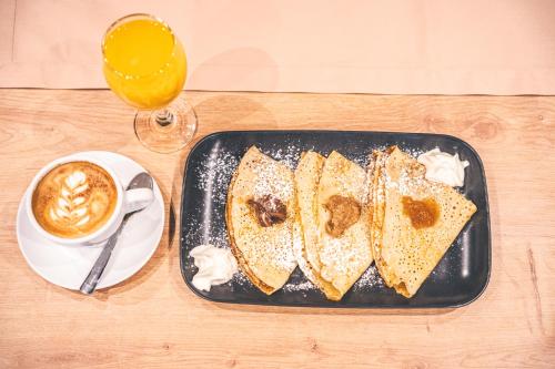 a tray with four slices of bread and a cup of coffee at Ruby restoran & prenoćište in Nova Gradiška