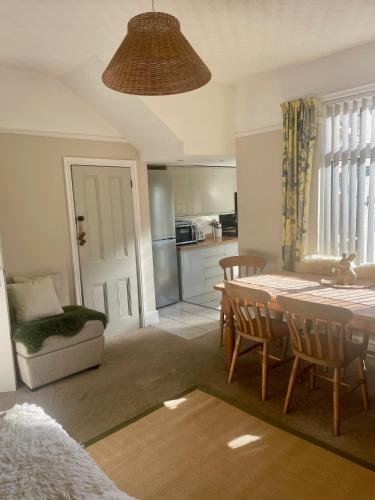 a kitchen and dining room with a table and chairs at 2025 Traveller award winner Just bring clothes in West Kirby