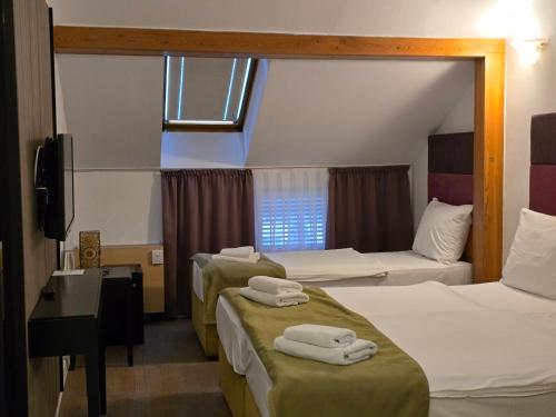 Voodi või voodid majutusasutuse Hotel Hecco toas