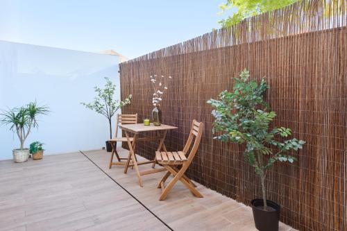 a patio with a table and chairs next to a brick wall at Unique Antas Park in Porto