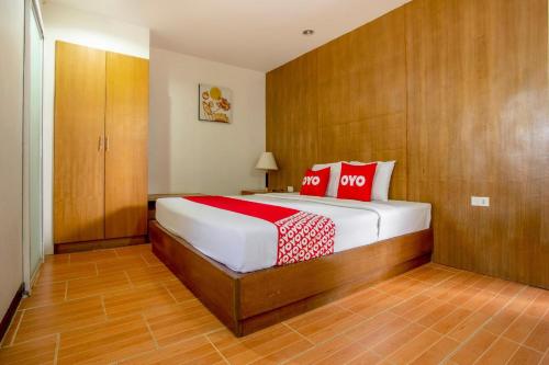 Un dormitorio con una cama con almohadas rojas. en Super OYO 1096 Winner Inn Hotel, en Chiang Mai