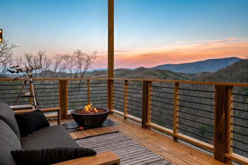 a view from the deck of a cabin with a fire pit at Reflections cabin in Sevierville