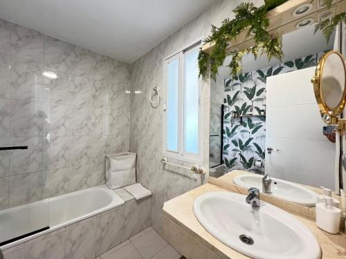 a bathroom with a sink and a tub and a toilet at PUSHE Village Albolote Business & Culture in Albolote