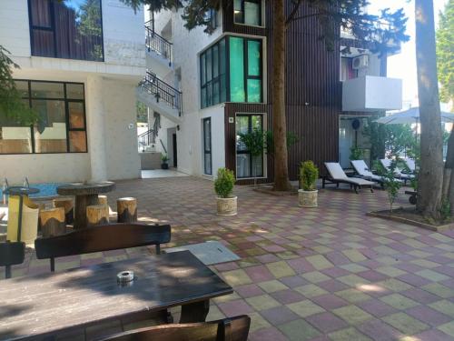 a patio with benches and tables in a building at Amara Butik on the first line in Ravda