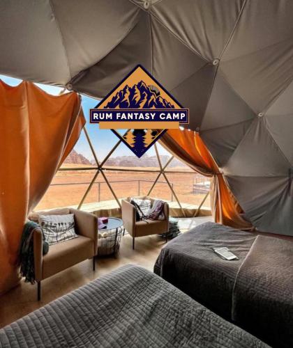 a room with a tent with two beds and chairs at RUM FANTAS BUBBLE lUXURY CAMP in Wadi Rum