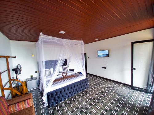 a room with a bed with a mosquito net at Ella Happy View Homestay in Ella