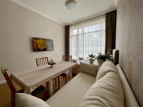 a living room with a couch and a table at Coral Bay Studio Varna - Beachfront with Free Parking in Varna City