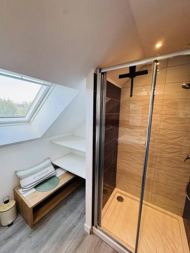 La salle de bains mansardée est pourvue d'une douche. dans l'établissement Confortable maison rénovée, jardin clos, 1km plage, à Quiberon