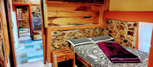 En eller flere senge i et værelse på The Kodai Heaven