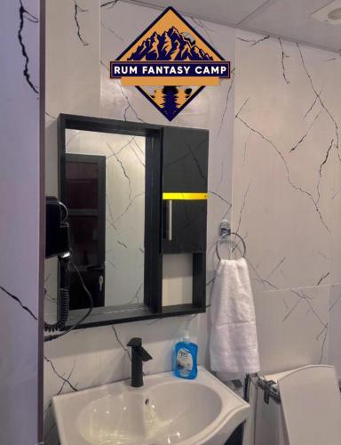 a bathroom with a sink and a mirror at RUM FANTAS BUBBLE lUXURY CAMP in Wadi Rum
