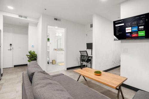a living room with a couch and a table at CozySuites Stunning 1BR in Downtown Pitts #4 in Pittsburgh
