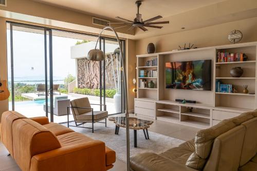 a living room with a couch and a table at White Monkey Villa - Private Pool & Jacuzzi in Pantai Cenang