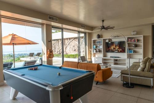 a living room with a pool table at White Monkey Villa - Private Pool & Jacuzzi in Pantai Cenang