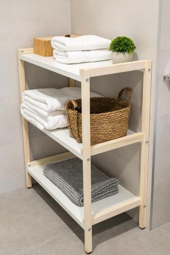 a shelf with towels and a basket on it at Main Lofts Valencia in Valencia