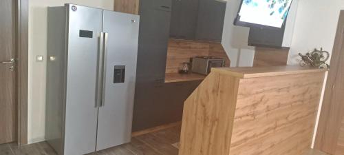 a kitchen with a white refrigerator and a counter at Vikendica-Villa Belvedere Srebrenik in Srebrenik