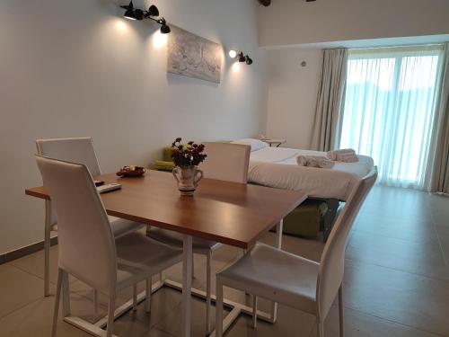 a dining room with a table and chairs and a bed at Don Vittorio Country Village in Taormina