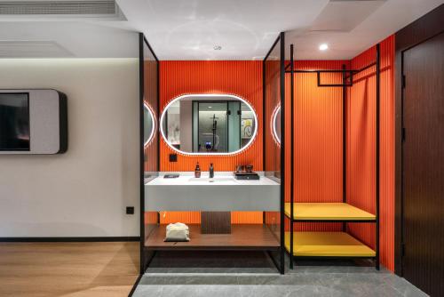 a bathroom with a sink and a mirror at NOX Hotel in Chengdu