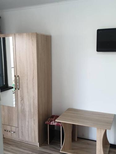 a wooden table in a room next to a door at Moonlight in Cholpon-Ata