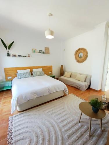 a bedroom with a large bed and a rug at B&B Villa Pinos Málaga in Alhaurín de la Torre