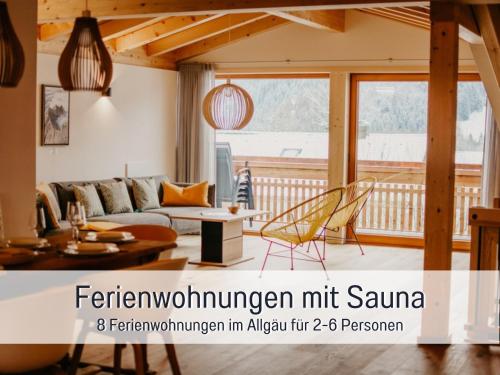 een woonkamer met een bank en een tafel bij Ferienwohnungen Scholl - private Sauna oder Infrarotkabine in Bad Hindelang