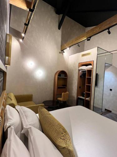 a room with a bed and a couch and a table at Hotel Du Cadran in Paris