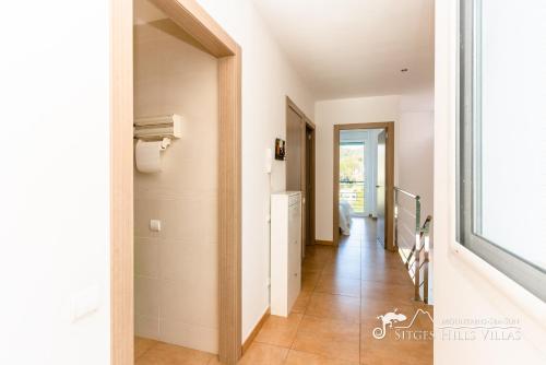 a hallway of a house with a staircase and a window at Villa Senita with Private Pool, close to Sitges in Olivella