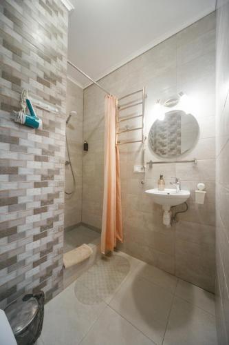 a bathroom with a shower and a sink at BonApart in Lviv
