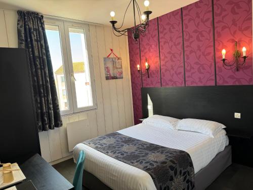 a bedroom with a large bed and a window at Hôtel Calme Des Pins & Spa in Les Sables-dʼOlonne