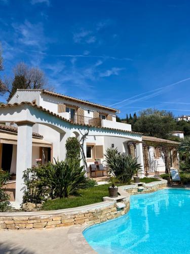 a house with a swimming pool in front of it at La Dolce Vita Opio in Opio