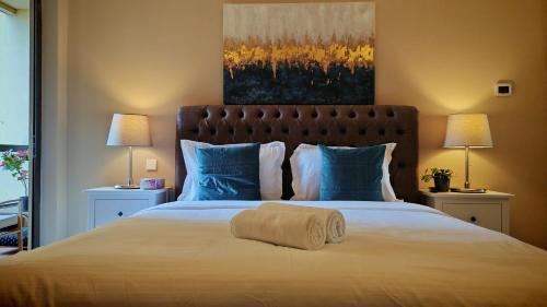 a bed with a rolled up towel on top of it at Modern, spacious, Luxe 5BR plus Maid condo in JBR, near JBR Beach, Marina view, By La Buena Vida Holiday Homes in Dubai