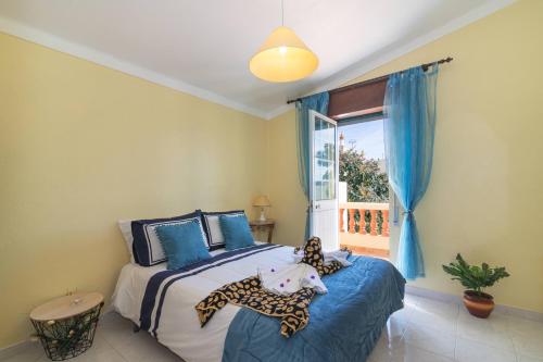 a bedroom with a bed with a stuffed animal on it at Casa do Sol - Estombar, Algarve in Estômbar