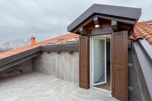 an extension to a house with a roof at Romana Luxury Suite - SELF CHECK-IN WI-FI in Oleggio