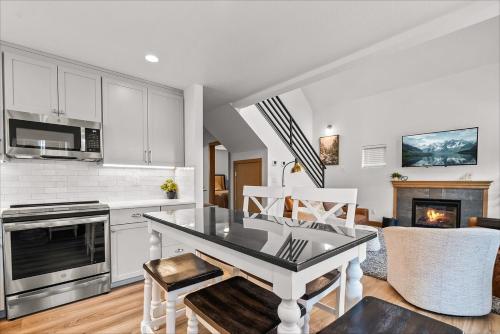 a kitchen with a table and a living room at Dover Wheelhouse in Dover