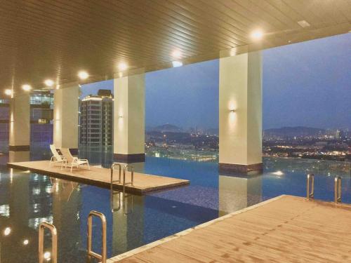 a swimming pool with a view of the city at Azure ParadigmPJ LeMeridienHotel in Petaling Jaya