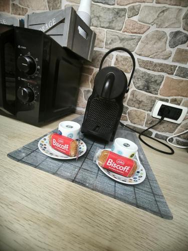 a counter with two cups of breakfast food and a microwave at Casa Vacanza Giorgia 2.0 in Marino