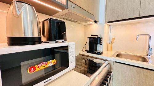 a kitchen with a microwave with a hot dog in it at Luxury 1-Bedroom Apartment At Burj Crown. in Dubai