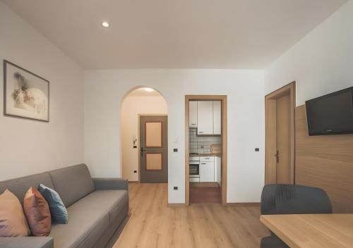 a living room with a couch and a table at New Residence Schnatzhof Schlanders in Silandro