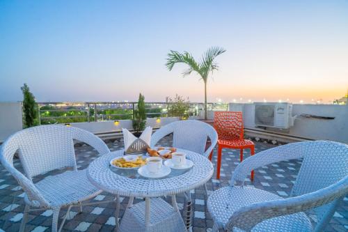 a table and chairs with a plate of food on a patio at HOTEL SNOOZE in Jaipur