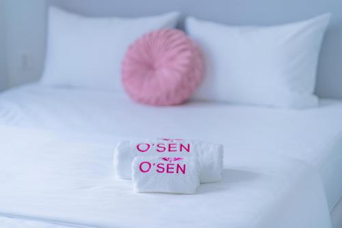 a pink doughnut sitting on top of a white table at Osen Hotel - Grand World Phu Quoc in Phu Quoc