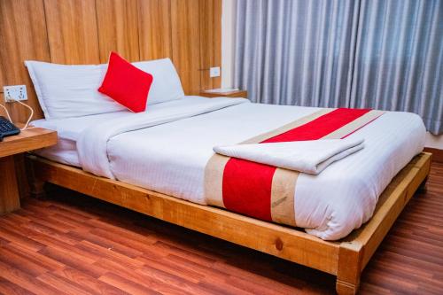 a bed with two red pillows on it in a room at Great Doors Thamel in Kathmandu