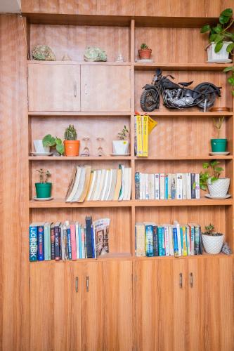 a book shelf with books and a motorcycle on it at Great Doors Thamel in Kathmandu
