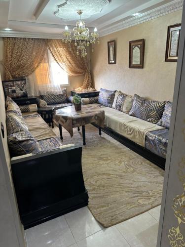 a living room with a couch and a table at appart 206 in Temara
