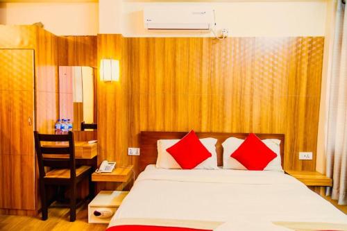 a bedroom with a bed with red pillows at Great Doors Thamel in Kathmandu