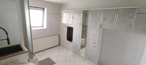 a white bathroom with a shower and a sink at Studio chez l'habitant - SDB privé in Tourcoing