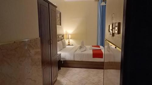 a hotel room with a bed and a glass door at Ruwi Beach Hotel Apartments - MAHA HOSPITALITY GROUP in Sharjah