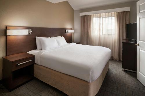 a hotel room with a large bed and a television at Residence Inn Pasadena Arcadia in Arcadia