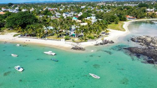 an aerial view of a beach with boats in the water at Quaint 2BDR beach apartment in a fishing village in Grand Gaube