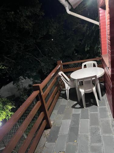 a table and chairs sitting on a patio at Apartamento Condominio Village dos Passaros Guarapari ES in Guarapari