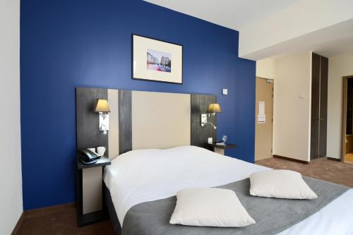מיטה או מיטות בחדר ב-Odalys City Montpellier Les Occitanes